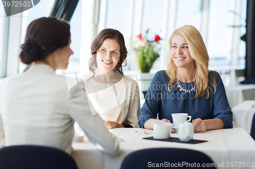 Image of women drinking coffee and talking at restaurant