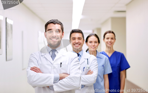 Image of group of happy medics or doctors at hospital