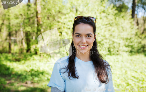 Image of happy young volunteer woman outdoors