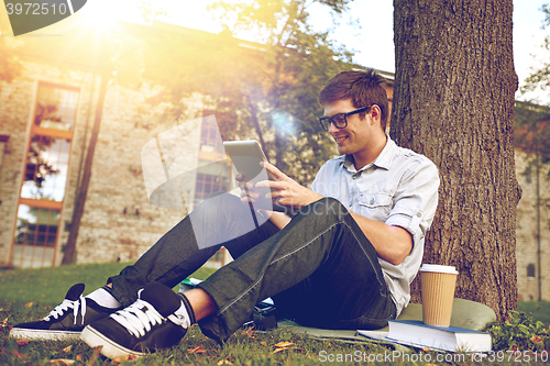 Image of happy teenage boy with tablet pc and coffee