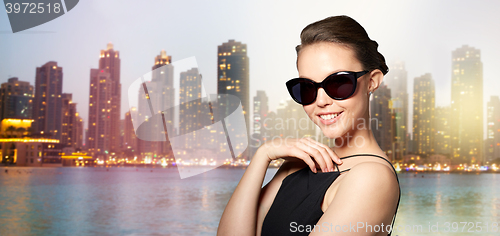 Image of beautiful young woman in elegant black sunglasses