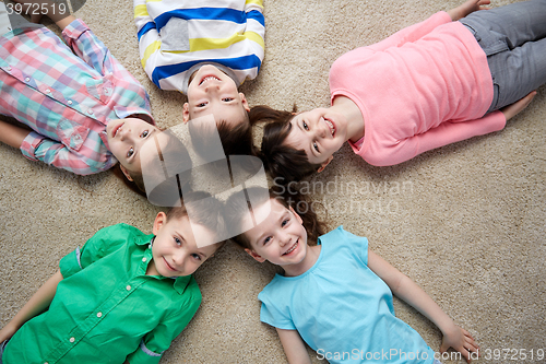 Image of happy smiling little children lying on floor