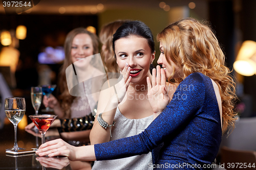 Image of happy women with drinks at night club