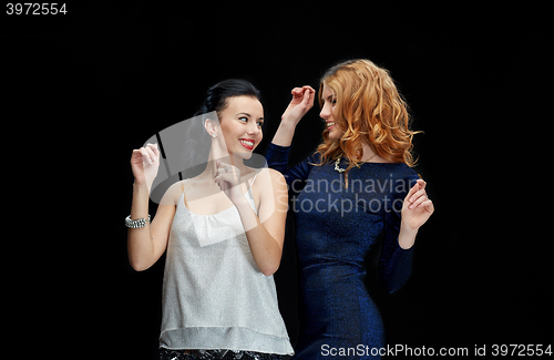 Image of happy young women dancing at night club disco