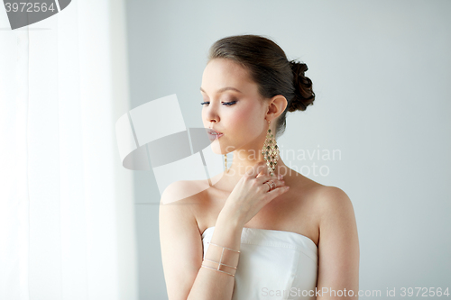 Image of beautiful asian woman with earrings and bracelet