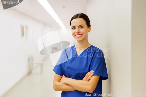 Image of happy doctor or nurse at hospital corridor