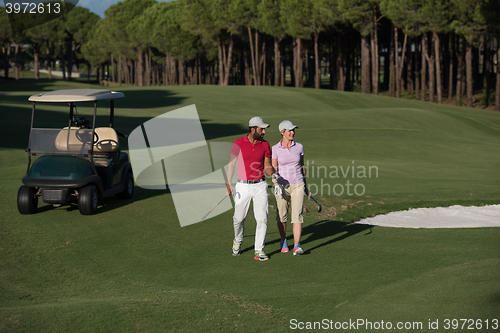 Image of couple walking on golf course