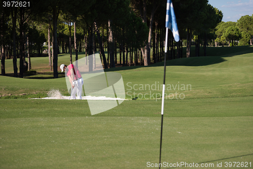 Image of golfer hitting a sand bunker shot