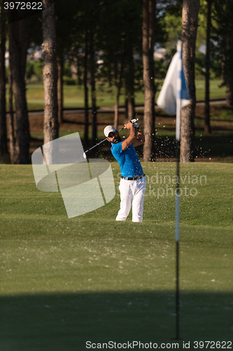 Image of pro golfer hitting a sand bunker shot