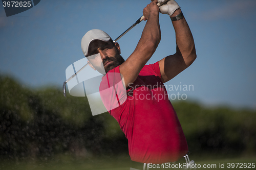 Image of golfer hitting a sand bunker shot