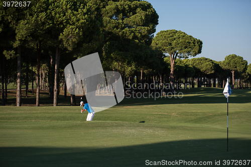 Image of pro golfer hitting a sand bunker shot