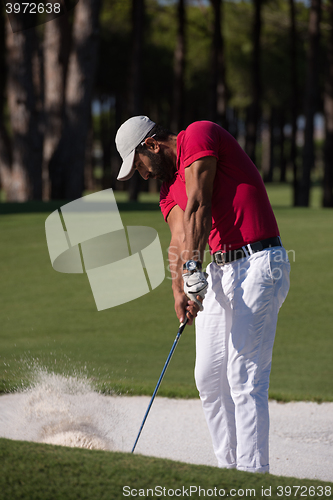 Image of golfer hitting a sand bunker shot