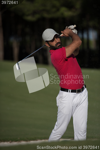 Image of golfer hitting a sand bunker shot