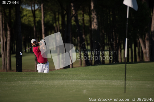 Image of golfer hitting a sand bunker shot