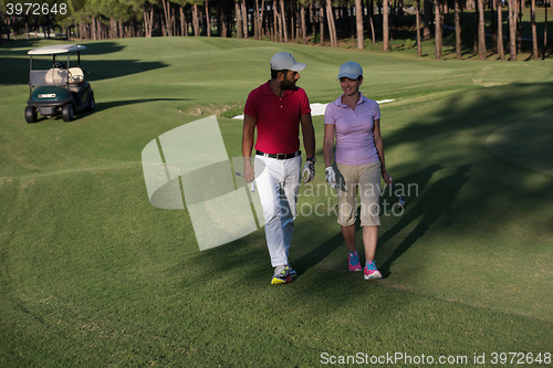 Image of couple walking on golf course