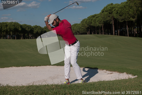 Image of golfer hitting a sand bunker shot