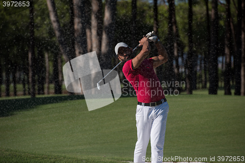 Image of golfer hitting a sand bunker shot