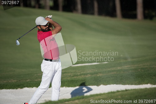 Image of golfer hitting a sand bunker shot