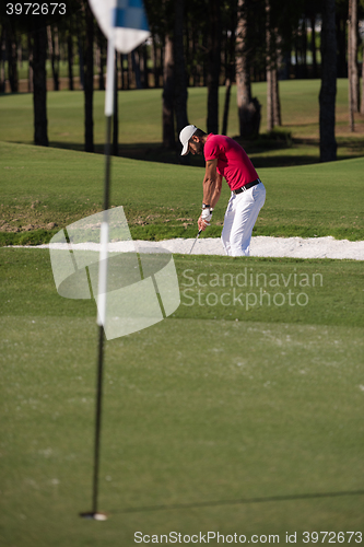 Image of golfer hitting a sand bunker shot