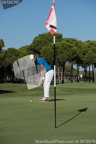 Image of golf player hitting shot at sunny day