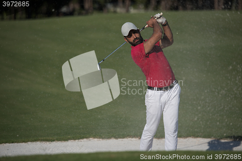 Image of golfer hitting a sand bunker shot