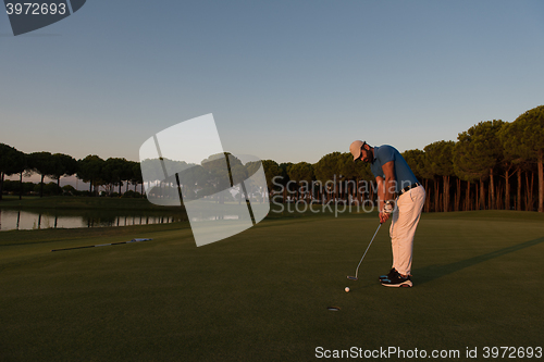 Image of golfer  hitting shot at golf course