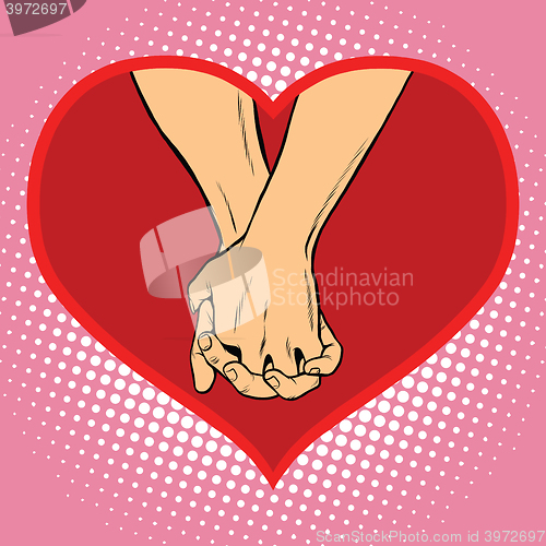 Image of Male and female hand together in a red heart symbol of love