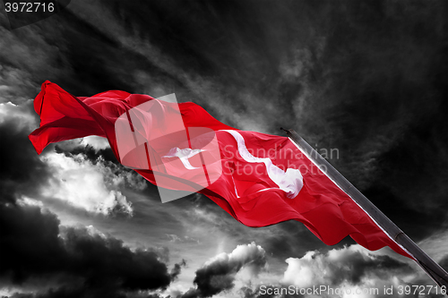 Image of Flag of Turkey waving against black and white sky