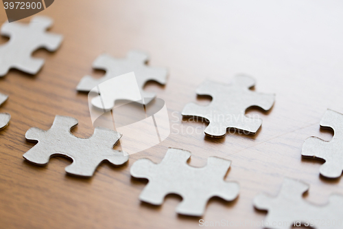 Image of close up of puzzle pieces on wooden surface