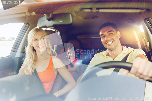 Image of happy family with little child driving in car