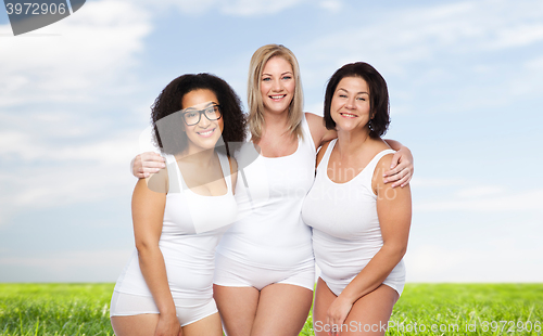 Image of group of happy plus size women in white underwear