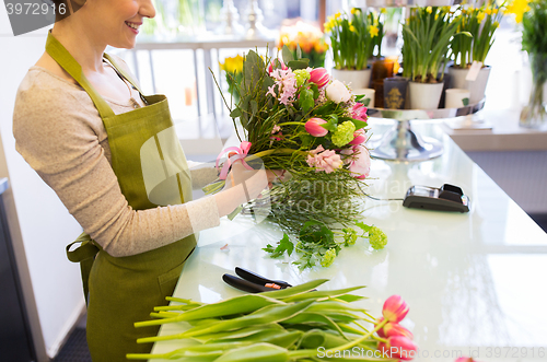 Image of close up of woman making bunch at flower shop