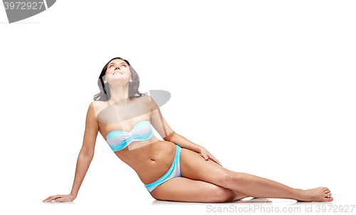 Image of happy young woman sunbathing in bikini swimsuit