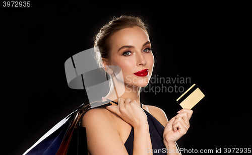 Image of woman with credit card and shopping bags