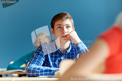 Image of group of students with notebooks at school lesson