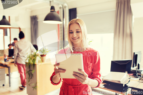 Image of happy creative female office worker with tablet pc