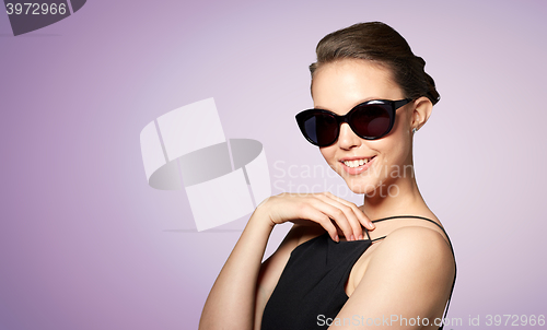 Image of beautiful young woman in elegant black sunglasses
