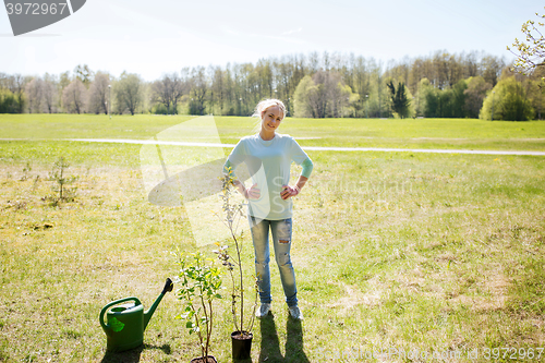 Image of happy young volunteer woman outdoors