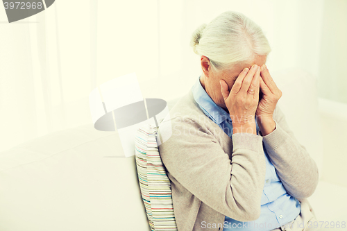 Image of senior woman suffering from headache or grief