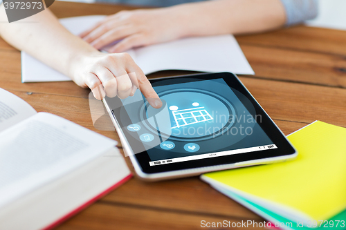 Image of close up of student with tablet pc and notebook