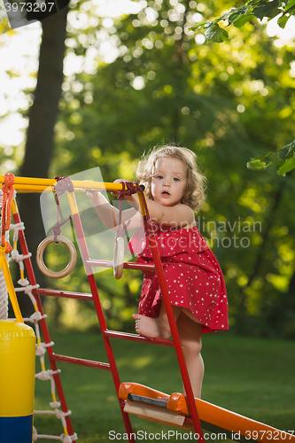 Image of The little baby girl playing at outdoor playground