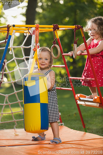 Image of The two little baby girls playing at outdoor playground