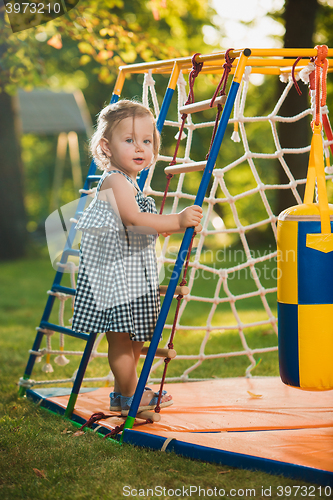 Image of The little baby girl playing at outdoor playground