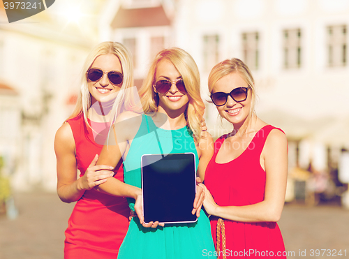 Image of beautiful tourist girls holding tablet pc