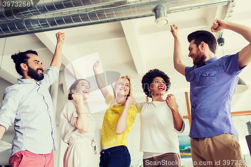 Image of happy creative team in office