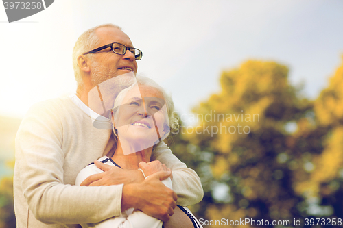 Image of senior couple hugging in park