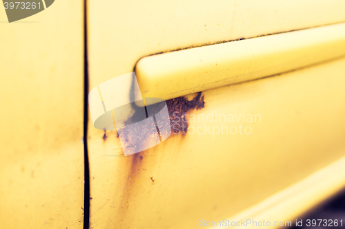 Image of close up of rusty car door surface