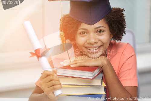 Image of happy african bachelor girl with books and diploma