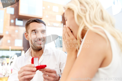 Image of man with engagement ring making proposal to woman