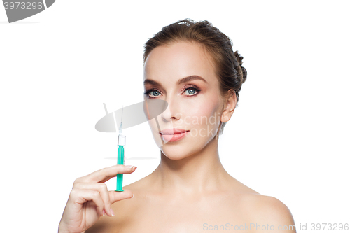 Image of beautiful woman holding syringe with injection